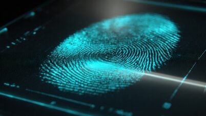 A glowing blue fingerprint displayed on a digital screen, shown in close-up with fine details and a futuristic, high-tech appearance.