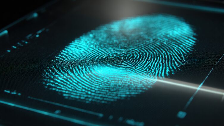 A glowing blue fingerprint displayed on a digital screen, shown in close-up with fine details and a futuristic, high-tech appearance.